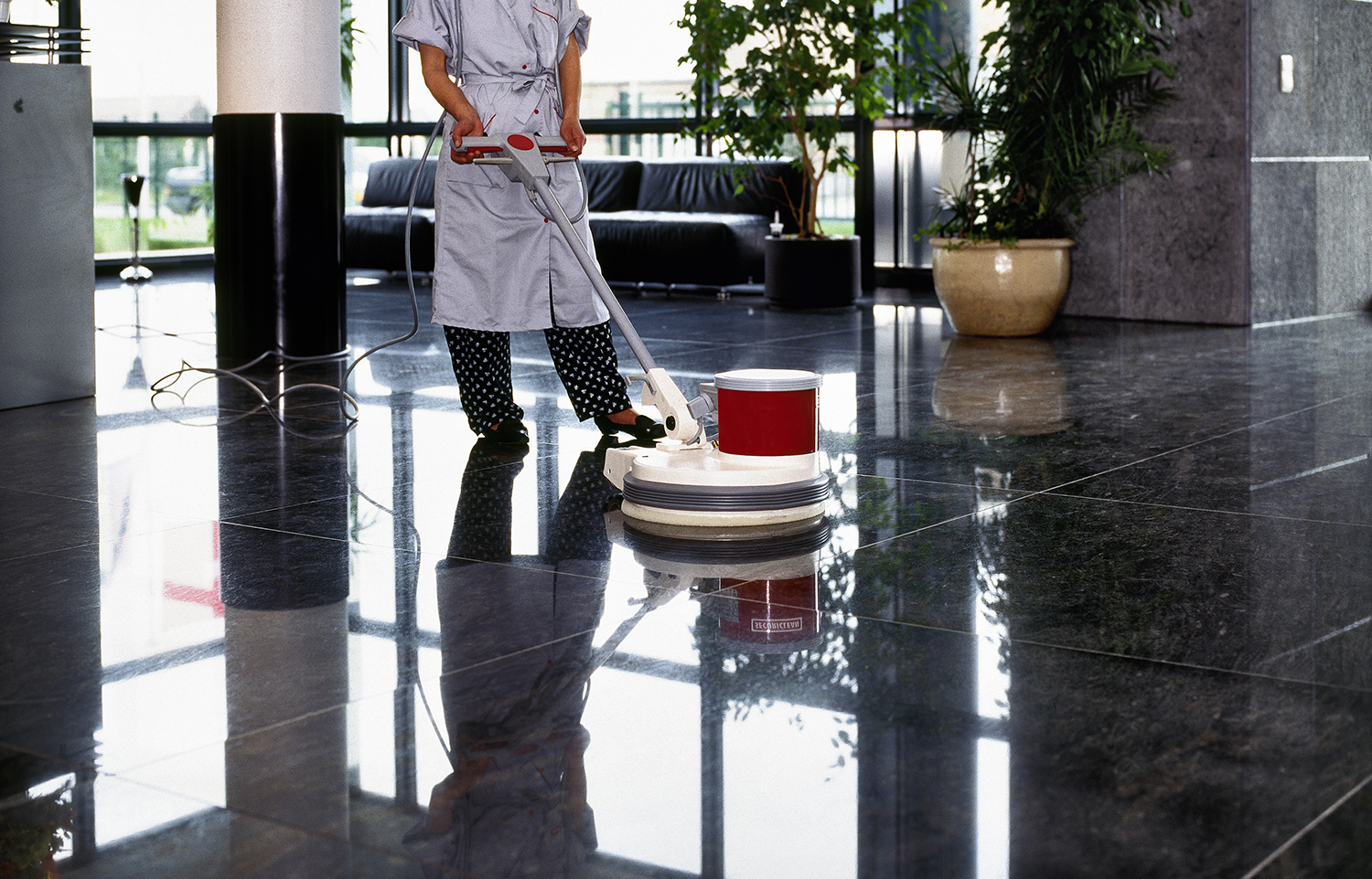 Adult cleaner maid woman with uniform cleaning corridor pass floor